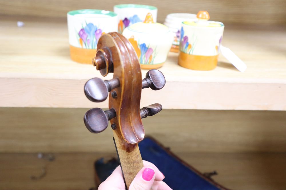 A cased violin, labelled Buthod, Paris, length of back 36cm, with bow stamped Tourte